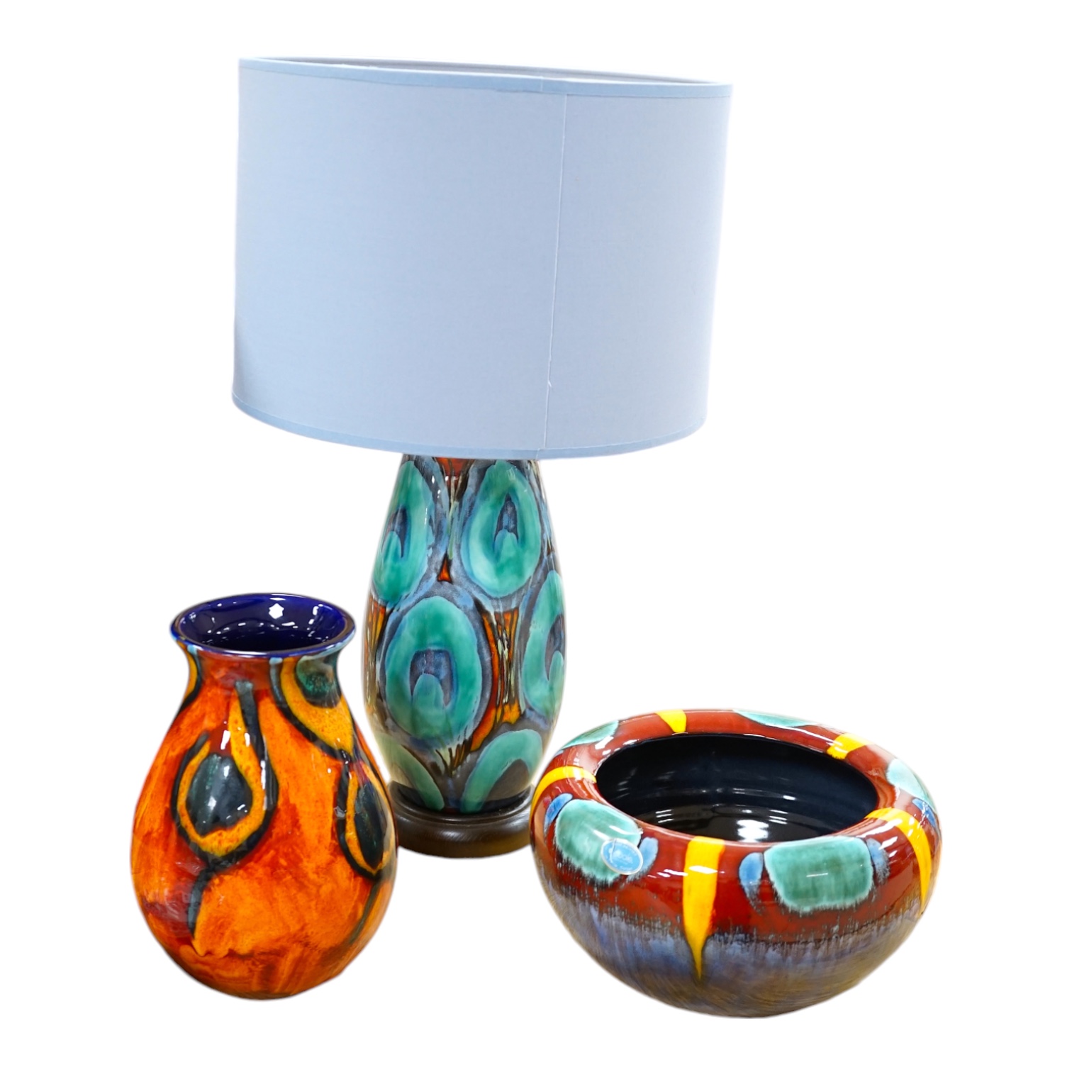 Three pieces of Poole pottery comprising Infusion concave bowl, a peacock design vase and a table lamp with shade, largest 51cm high. Condition - good